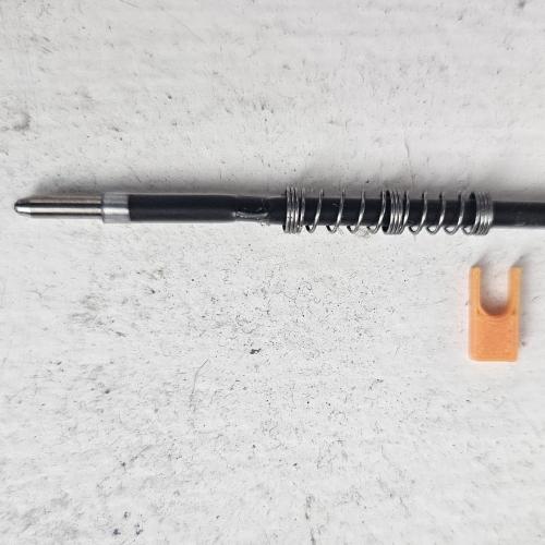 The ballpoint cartridge next to the printed clamp that holds its spring